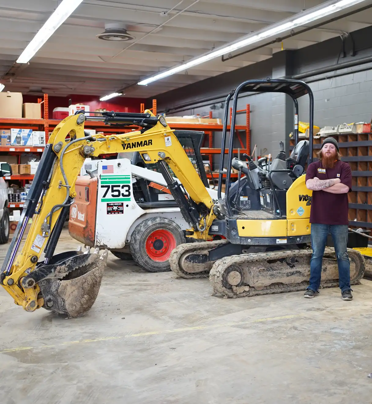 Plumber standing in front of an excavator