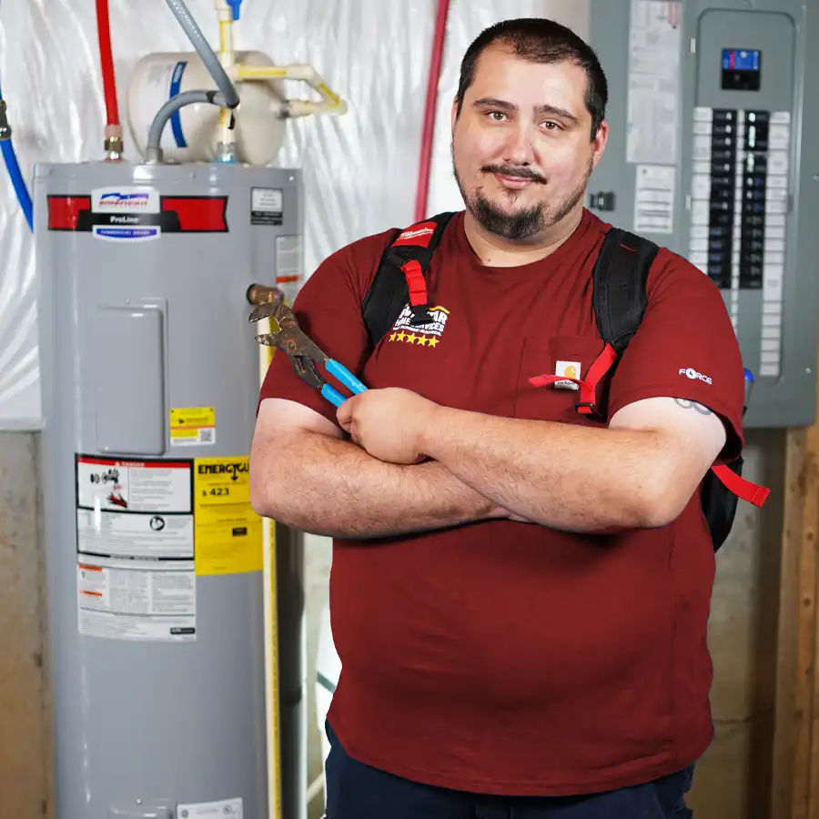 Plumber with a wrench in front of a water heater