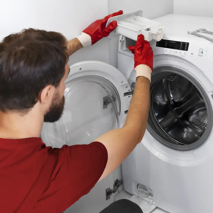 Plumber fixing a washing machine