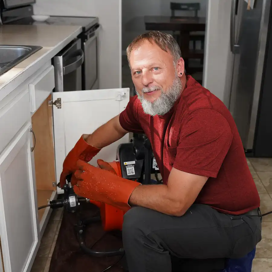 Plumber fixing a garbage disposal