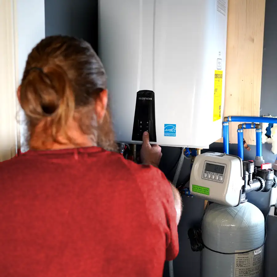 Plumber working on a tankless water heater