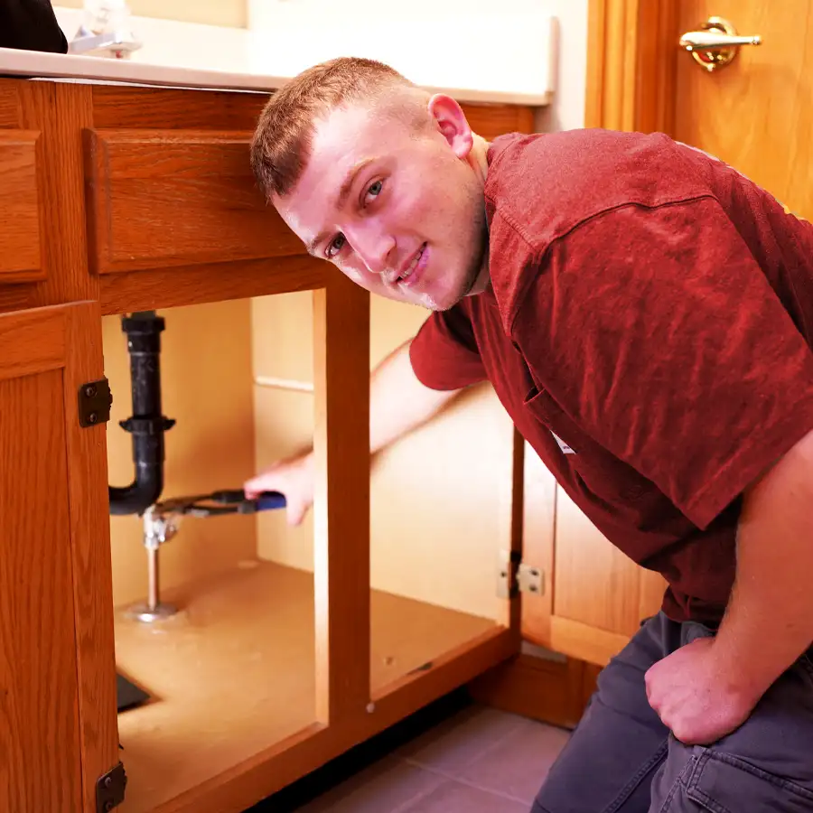 Plumber fixing a bathroom sink