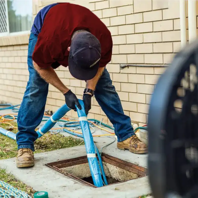 plumber working with a trenchless sewer line