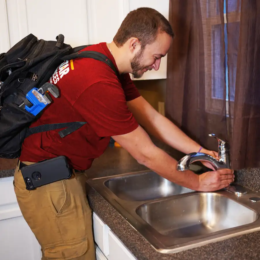 Plumber fixing a sink