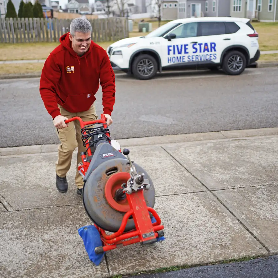 Plumber with video camera inspection equipment